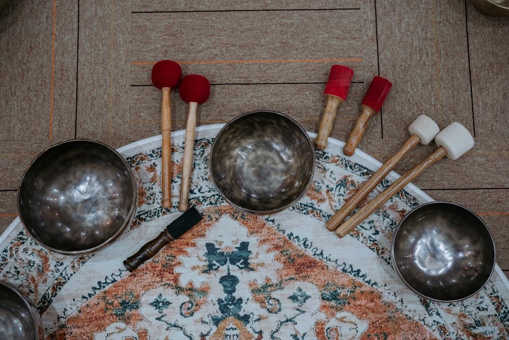 Traditional handcrafted singing bowls and sound therapy tools in serene stillness
