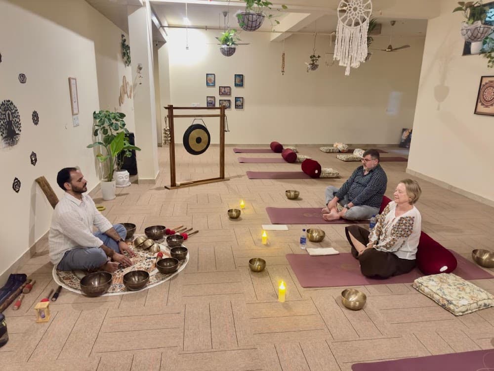 Founder Samir guiding meditation with bowl mandala