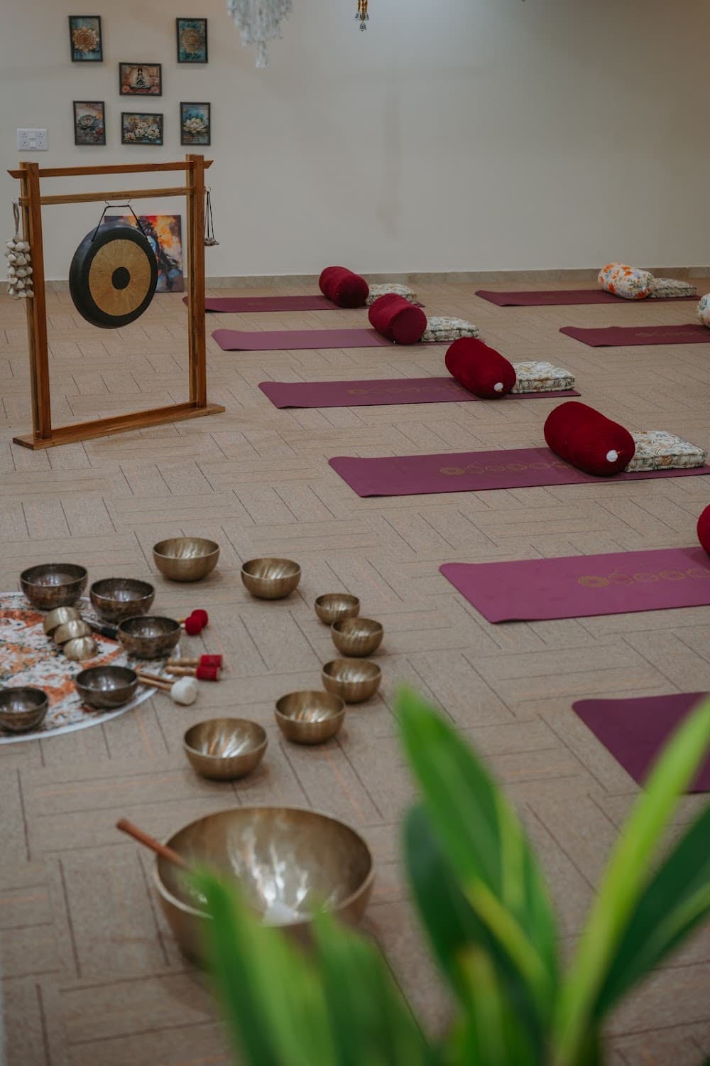 Tranquil studio interior with singing bowls, gong, and sound meditation mats